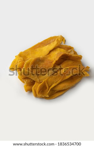 Dried mangos are placed on a white background.