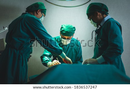 Professional surgical doctor team operating surgery patient in operating room at hospital