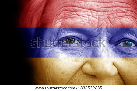 Portrait of older lady with painted national flag of Armenia