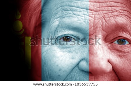 Portrait of older lady with painted national flag of Mongolia