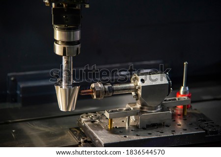The 4-axis sinker EDM machine operation . The hi-technology mold and die manufacturing process by sinker EDM machine . Royalty-Free Stock Photo #1836544570