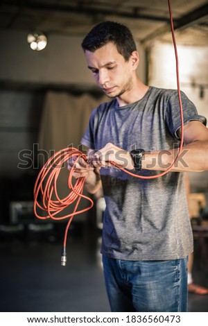 Behind the scene. Sound engineer is connecting the audio cables in the theater