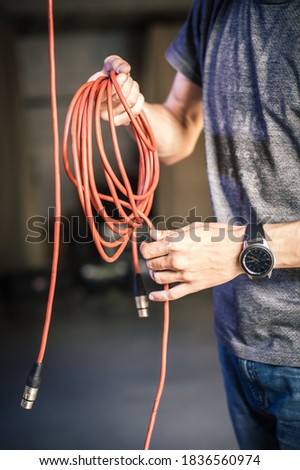 Behind the scene. Sound engineer is connecting the audio cables in the theater