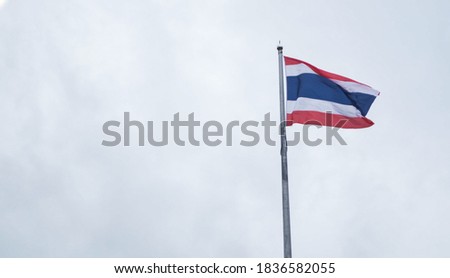 Thailand flag on the pole.Thailand flag on rain cloud background.