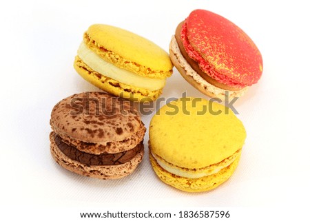 Macarons with cream on white background, closeup.