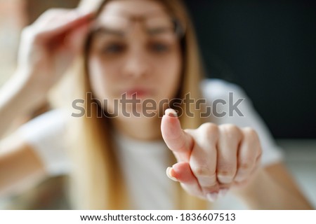 A woman has vision problems, squints when trying to see something, takes off her glasses, is isolated. Myopia, hyperopia, vision concept. High quality photo. Royalty-Free Stock Photo #1836607513