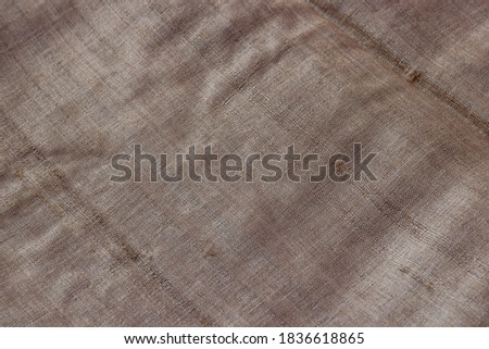 Close-up of Indian traditional silk fabric textile material. Texture background concept, selective focus.