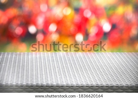 wicker, rattan table and blurred autumn background. Autumn, nature concept. copy space. 