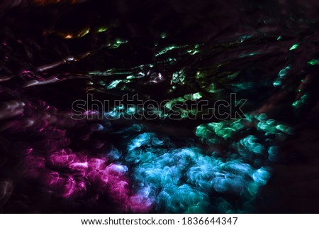 Beautiful multi colored abstract optical light bokeh on a dark background.	