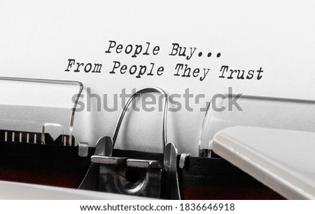 Text People Buy From People They Trust typed on retro typewriter.