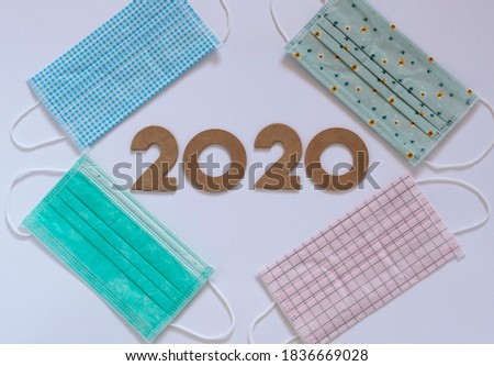 Face masks and 2020 number top view background