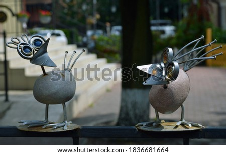 Figures of birds with funny expressions of the muzzle, made with their own hands from stone and iron.