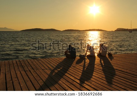 Three man, shadows and sunset 