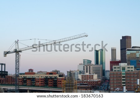 Part of the Denver skyline with a crane, taken from the 7th floor of a nearby apartment building. 