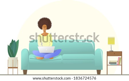 A cute girl with curly hair works at a laptop while sitting on the couch. Freelancer works from home. Vector flat illustration