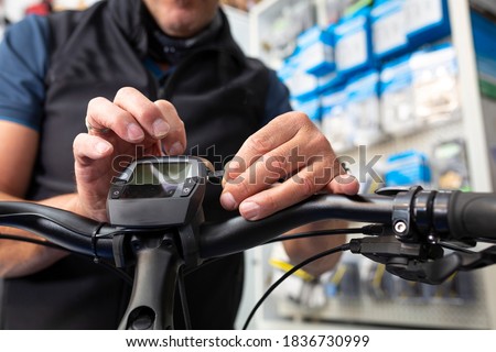 Bike mechanic maintains an e-bike