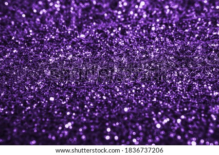 Purple glitter texture  sparkling shiny paper background for Christmas holiday wallpaper decoration, greeting and wedding invitation card design element, Xmas abstract background with copy space.