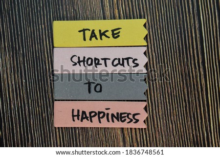 Take Shortcuts to Happiness write on sticky notes isolated on Wooden Table. Motivation or Insipiration Concept Royalty-Free Stock Photo #1836748561