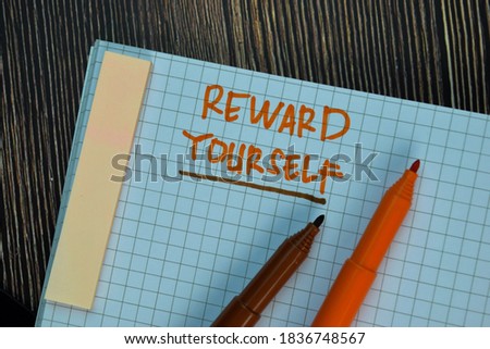 Reward Yourself write on a book isolated on Wooden Table. Motivation or Insipiration Concept Royalty-Free Stock Photo #1836748567