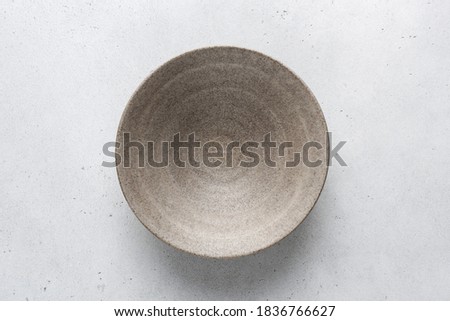 Homemade grey ceramic bowl. Craft ceramics, pottery concept Royalty-Free Stock Photo #1836766627