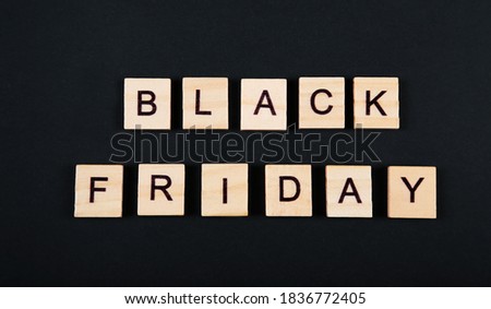 Black Friday, sale message, sign. Black friday sale poster or banner. Wooden letters on black background. 