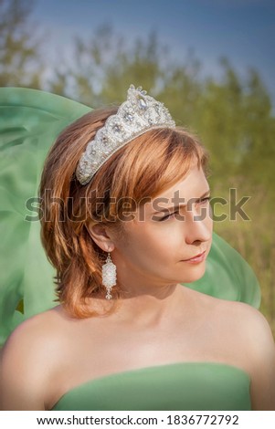 Portrait of a girl in a snow-white crown. Creative photo retouching with a girl in a crown. 