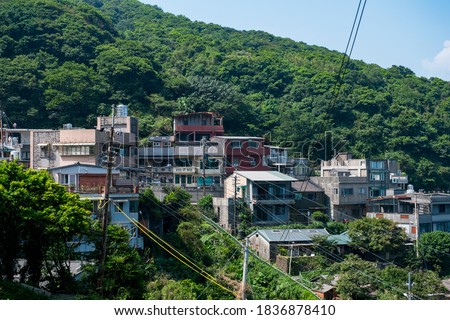 landscape view of JiuFen Village with mountain residental buildings and blue sky. Ruifang District, New Taipei City, Taiwan