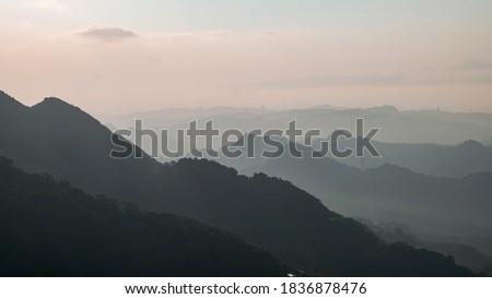 A Landscape panorama view of ocean and mountain with the beautiful sky. Taking photos during dusk at Jiufen Village.