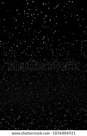 Abstract black blured sparkling background with focused area. Holiday festive concept. Glitter confetti. Christmas lights. 