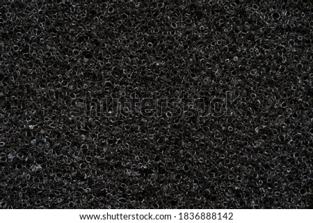 Close up of black absorbing sponge, acoustic foam detail.