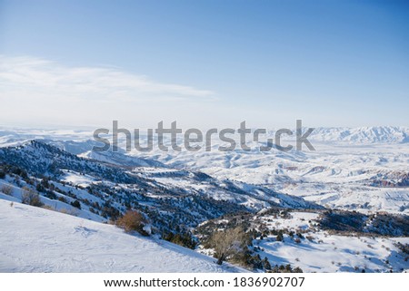 Mountain peaks covered with snow in Uzbekistan on a clear day. Beldersay ski  