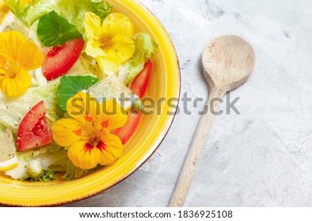 Colorful food, fresh veggie salad in yellow colors in ceramic bowl, with wooden spoon. Healthy life concept. Color 2021