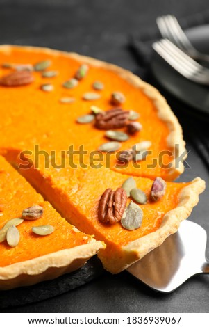 Delicious homemade pumpkin pie on black table, closeup