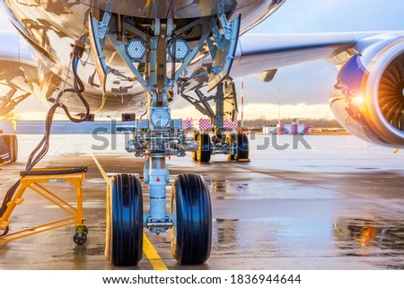 Front landing gear landing lights and connected ground power under the fuselage of the aircraft Royalty-Free Stock Photo #1836944644