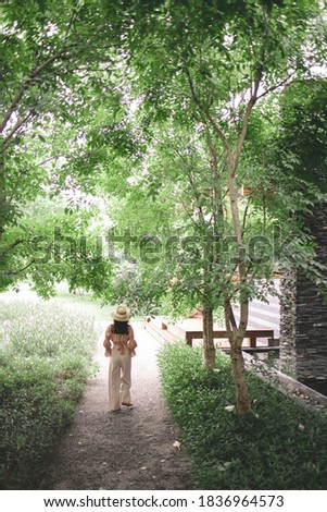 Asian Travelling tour happy in vacation summer Tourist Traveler Teenon background view Traveling Trip Sightseeing Tourism concept. Back view traveler woman looking at uncontaminated minimal nature