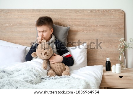 Ill coughing little boy at home Royalty-Free Stock Photo #1836964954