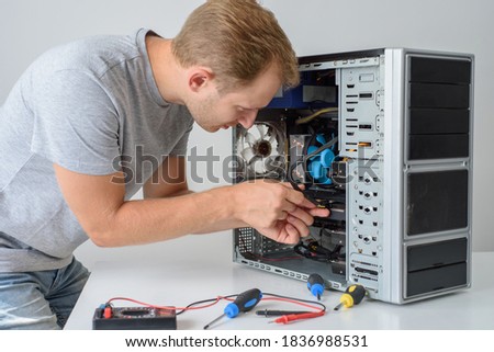 A man fixing a computer. Closeup