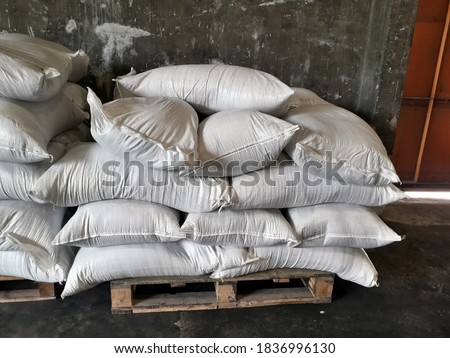 Chemical fertilizer The product stock is packed in sacks, stacked in the warehouse, waiting for delivery.	