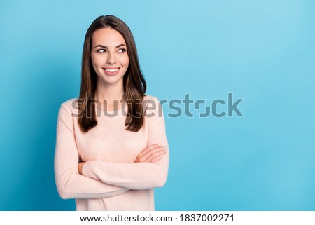 Photo of positive attractive lady look empty space cross hands wear beige sweater isolated over blue color background
