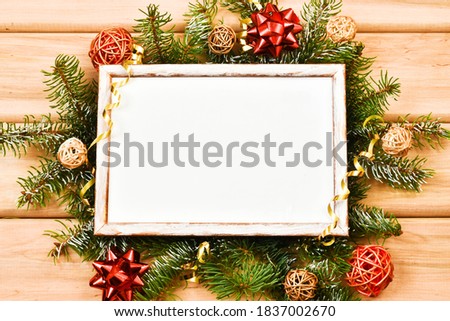 Christmas frame mockup for greeting card on a wooden background. Christmas greeting card, banner. Winter holiday theme. Happy New Year. Space for text.