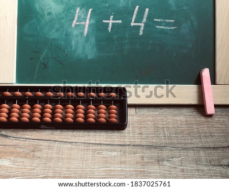 School desk with chalk and abacus.  Concept for Teacher’s Day, copy space.