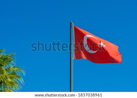 Flag of Turkey rise waving to the wind with sky in the background. Waving national flag of Turkey. Travel, tourism.