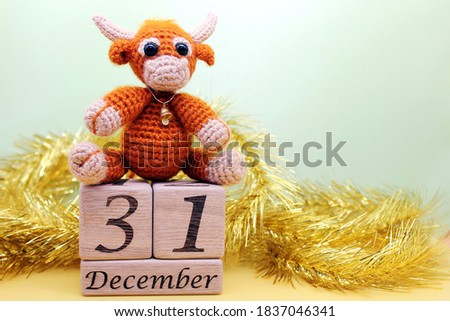 Toy bull. Symbol of the new year 2021. Date December 31 on wooden blocks. Happy New Year.