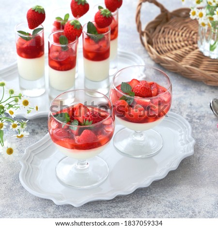 Delicious panna cotta with fresh strawberry in glasses