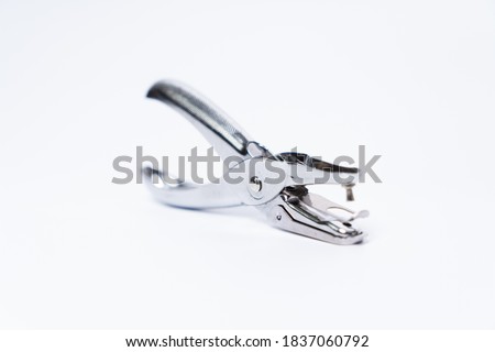 Metal Paper Hole Puncher Isolated on White Background.