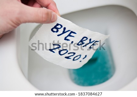 Conceptual image of toilet paper, symbol of covid-19 crisis and pandemia in 2020. Abstract image, saying goodbye to the bad year, leaving the past behind, hoping for better. Royalty-Free Stock Photo #1837084627