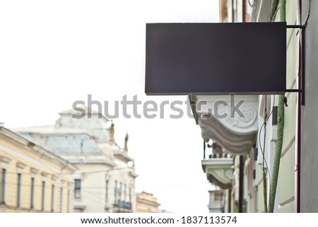 Rectangular sign on the building. Copy space and space for text. Mockup for design. Blank template for advertising.