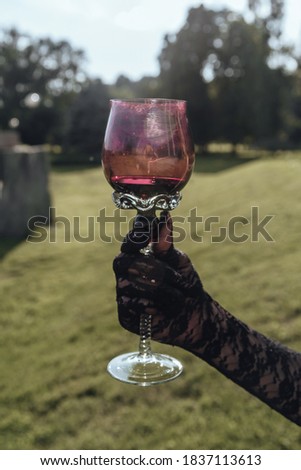 gothic girl drinking wine outdoor
