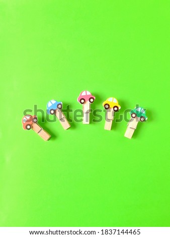 Top view of cute wooden paper clip with shocking green background paper. Top view. 