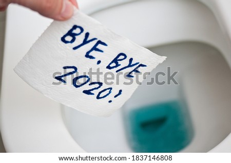 Conceptual image of toilet paper, symbol of covid-19 crisis and pandemia in 2020. Abstract image, saying goodbye to the bad year, leaving the past behind, hoping for better. Royalty-Free Stock Photo #1837146808